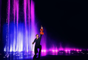 Violin performer with water light show
