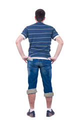 Obraz premium young man looks at white background. rear view.