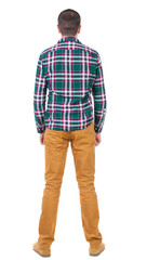 Fototapeta premium Back view of handsome man in checkered shirt looking up.