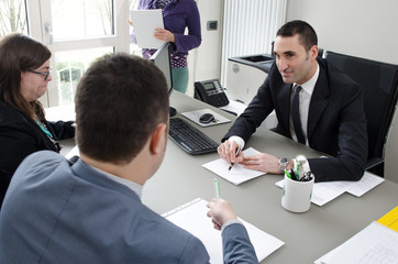 Co-workers discussing business plan in office