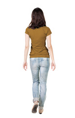 Obraz premium back view of walking woman in jeans .