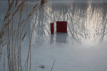 
Red chair on frozen lake