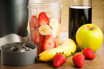 Strawberry smoothie preparing a frout meal in the kitchen