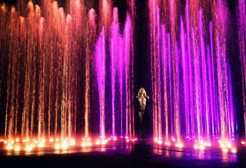 Woman in front of light and water show