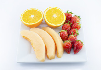 Fresh fruits in plate on white : Melon,Strawberry,Orange