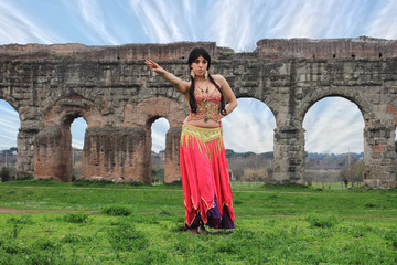 belly dancer with ancient Roman aqueducts ruins