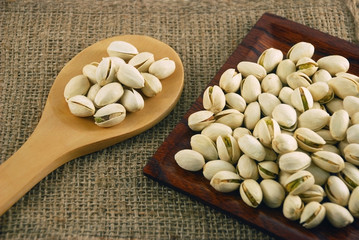 pistachio nuts on a wooden ladle