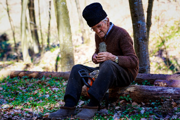 old man sharpening a chainsaw