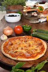 pizza and fresh vegetables for pizza on the wooden background