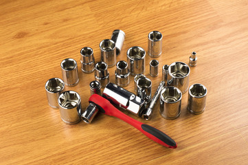Ratchet and a set of different attachments to tighten the bolts