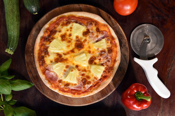 Hawaiian Pizza , pineapple , ham and cheese on wooden background