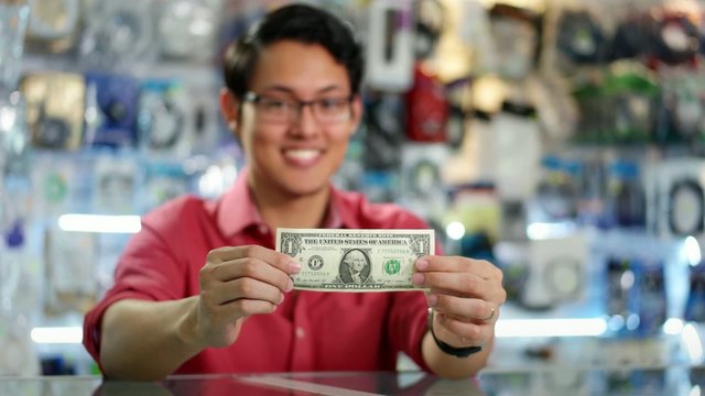 Happy Chinese Computer Shop Owner Showing First Dollar
