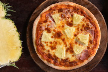 Hawaiian Pizza , pineapple , ham and cheese on wooden background