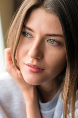 Obraz premium Beautiful young lady relaxing by window