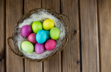 Basket full of colorful painted eggs