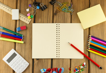 Blank notebook with school and office supplies