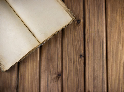Top view of blank old grange book on vintage wooden background