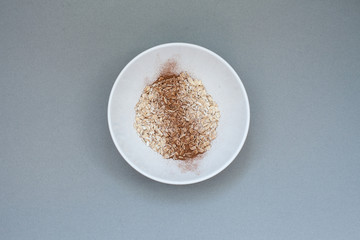 Candid photo: grey background: plate with oatmeal