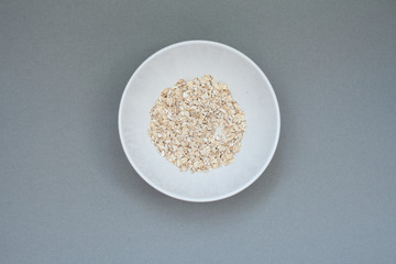 Candid photo: grey background: plate with oatmeal