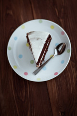 Chocolate cake in white plate on wooden table