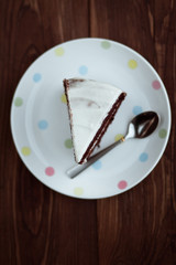 Chocolate cake in white plate on wooden table