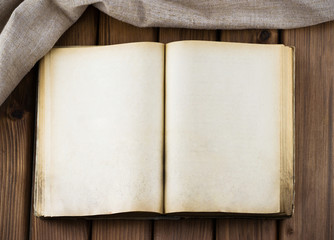 Top view of blank old book with vintage pages and sackcloth