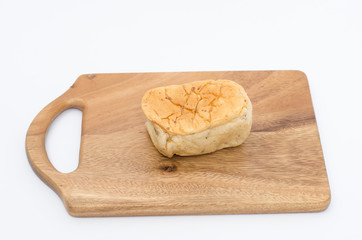 Bread slices on wood cutting board on white background