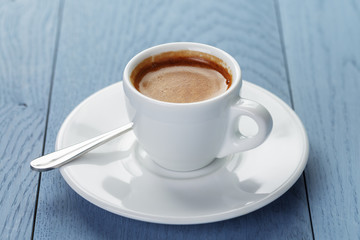 cup of fresh espresso on vintage blue table