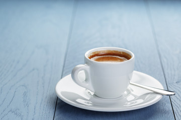 cup of fresh espresso on vintage blue table