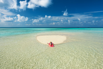 Woman relaxing on inflatable mattress