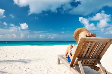 Young woman reading a book at beach