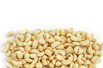 border of dry cashew nuts on white background
