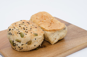 Bread on wood cutting board on white background