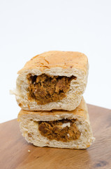 dried shredded pork bread on cutting board on a white background