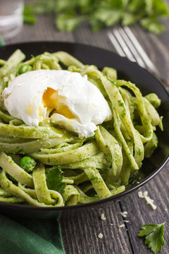 Tagliatelle pasta with spinach and green peas pesto poached egg