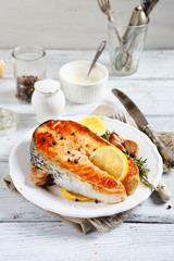 Salmon steak with lemon on a plate