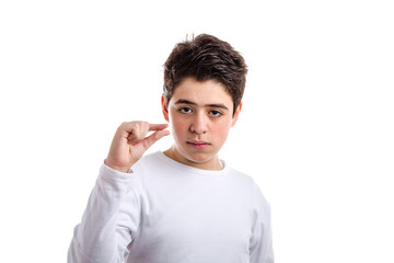 Pinching gesture with thumb and index finger by Caucasian boy wi