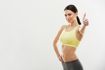 Happy fitness Young Woman Showing Thumbs Up.