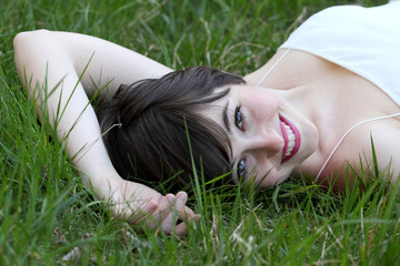 Happy cute girl on green field