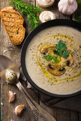 Mushroom cream soup on rustic background