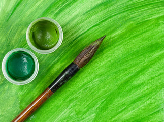 Vintage artist's paintbrush tool with two cups of gouache paint
