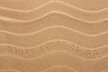 Aruba inscription on the wavy sand