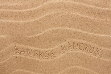 Bangkok inscription on the wavy sand