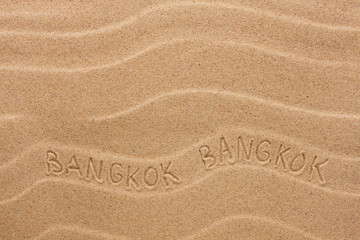 Bangkok inscription on the wavy sand