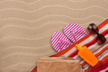 Women's accessories for the beach lying on the sand