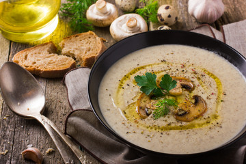 Mushroom cream soup on rustic background