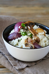 Tasty rice with mushrooms and onions in a bowl