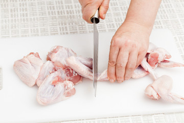 cutting raw chicken wings