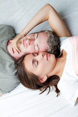 Obraz na płótnie Canvas loving couple relaxing on bed