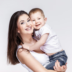 happy mother with a child on light grey background